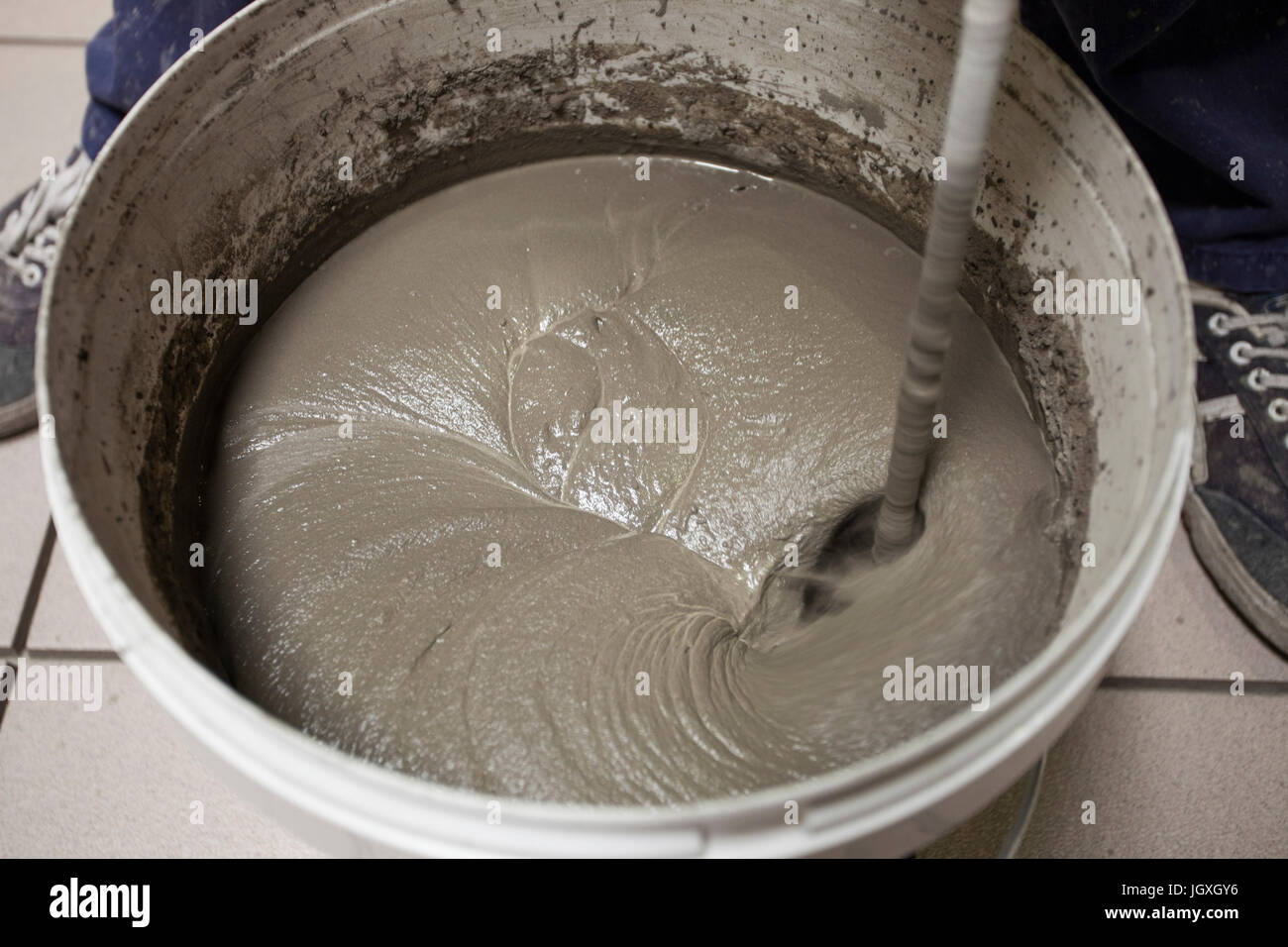 Preparation of tile adhesive with bucket stirrer Stock Photo