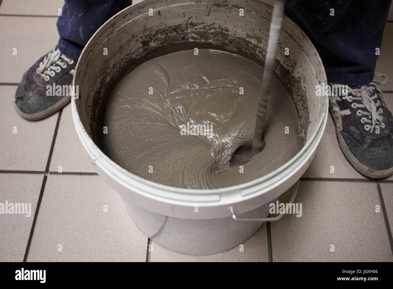 Preparation of tile adhesive with bucket stirrer Stock Photo