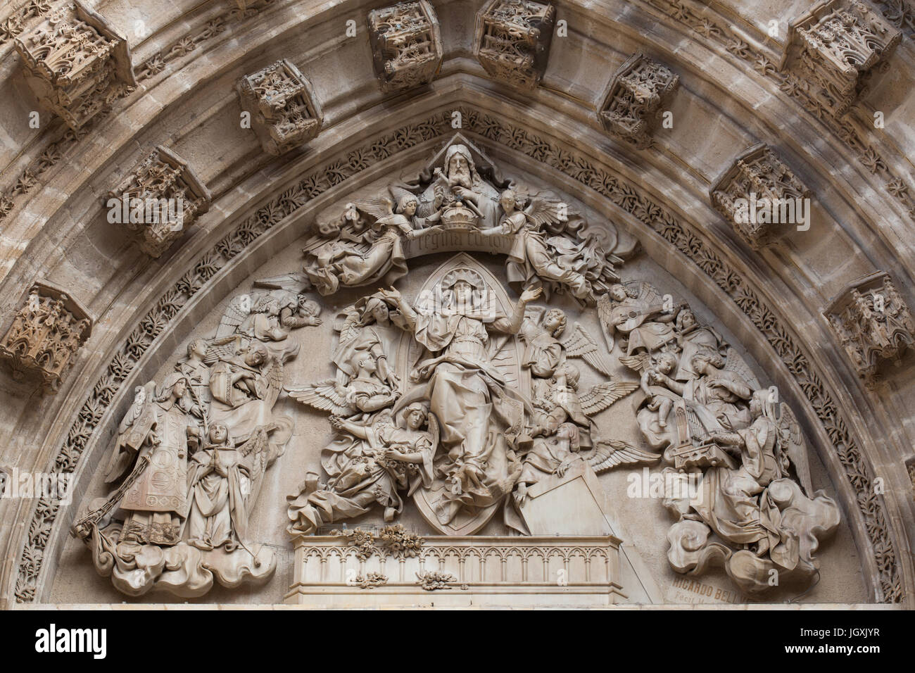 Assumption of Mary. Tympanum by Spanish sculptor Ricardo Bellver (1882) on the Portal of the Assumption (Puerta de la Asunción) of the Seville Cathedral (Catedral de Sevilla) in Seville, Andalusia, Spain. Stock Photo