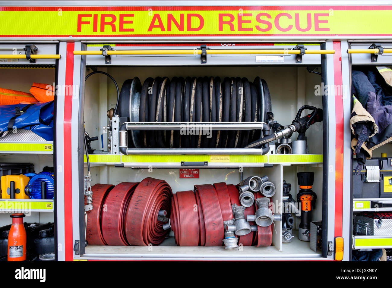 Firefighting fire-fighting and rescue equipment in a British fire engine truck tender. Stock Photo