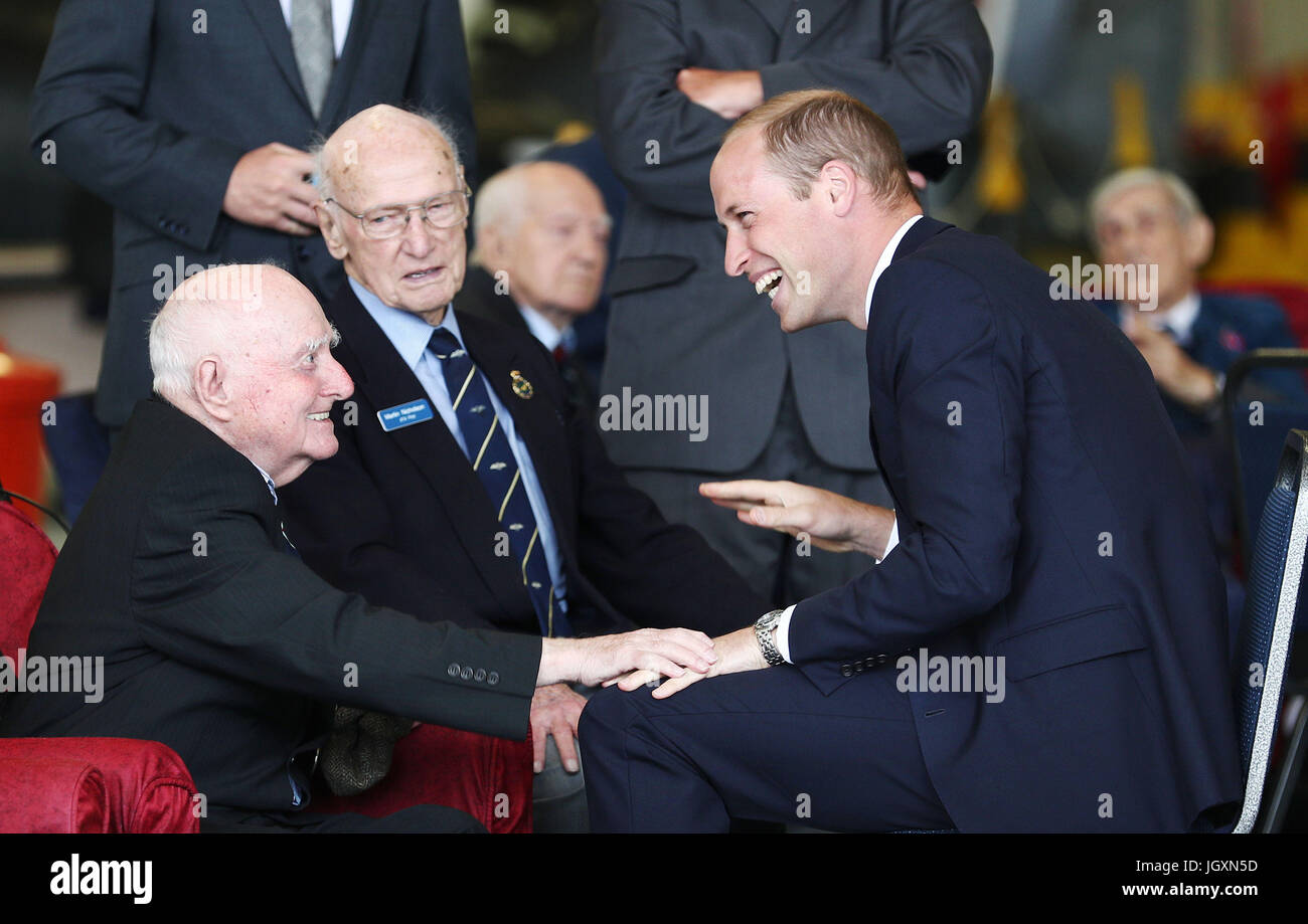 The Duke of Cambridge speaks with veterans during a reception to mark the Battle of Britain Memorial Flight's 60th anniversary during his visit to RAF Coningsby in Lincolnshire. Stock Photo