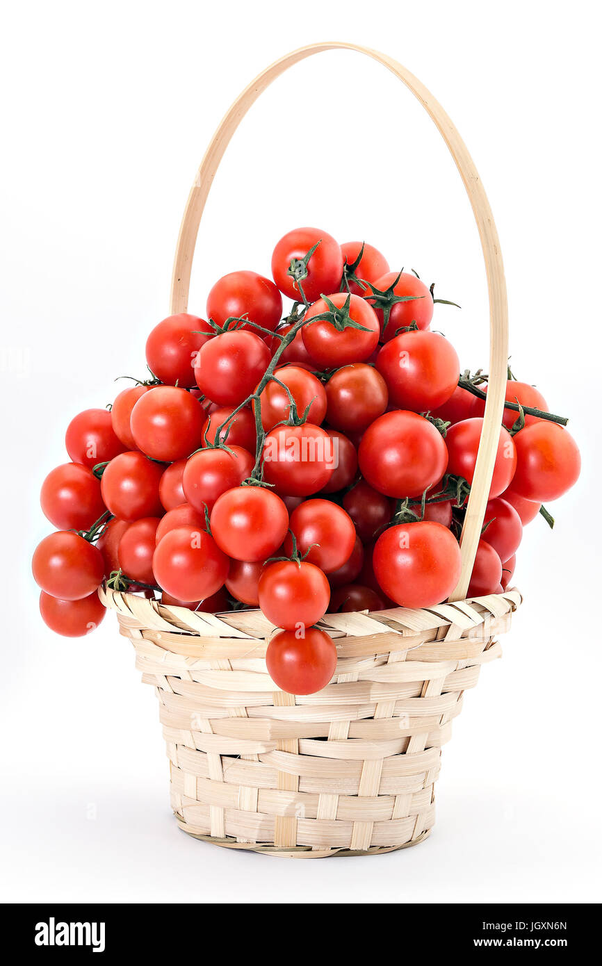 Cherry tomatoes in wooden basket on white background Stock Photo - Alamy