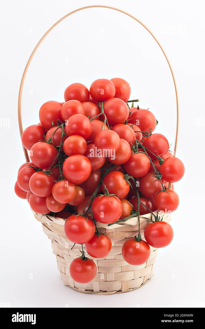Cherry tomatoes in wooden basket on white background Stock Photo - Alamy