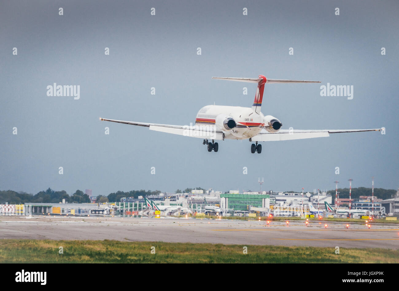 A Meridiana airliner commercial airplane lands at Milan's Linate airport Stock Photo