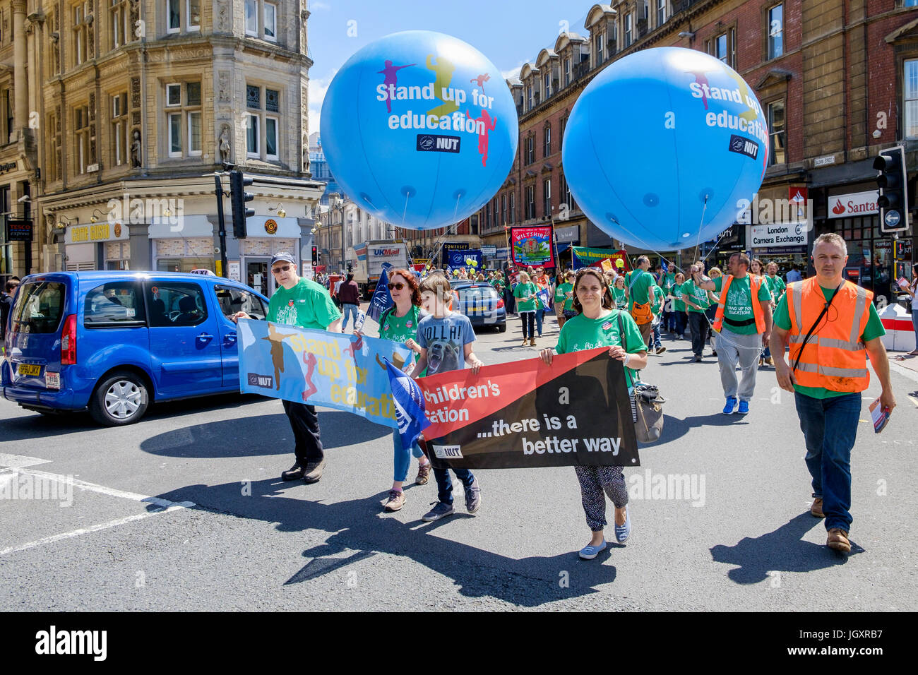 Striking teachers and their supporters are pictured as they make their way through Bristol city centre during a NUT protest march and rally Stock Photo