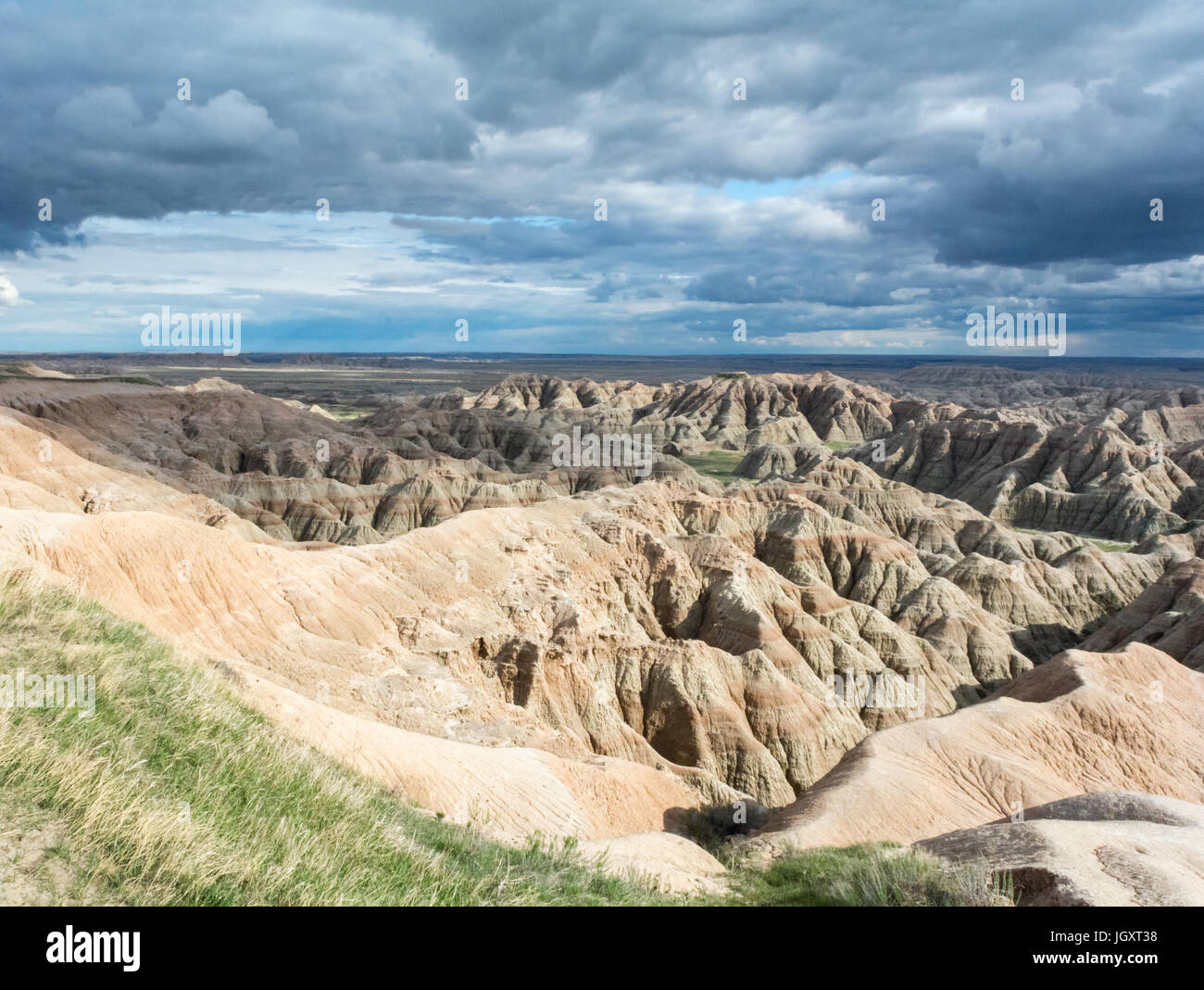 Grey Clouds swept over the dry ravines of the Bad Lands. Stock Photo