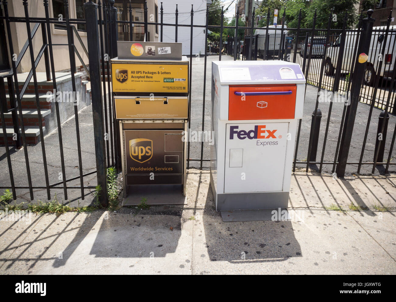 FedEx and UPS drop off boxes next to each other in the Astoria neighborhood of Queens in New York on Sunday, July 9, 2017. (© Richard B. Levine) Stock Photo