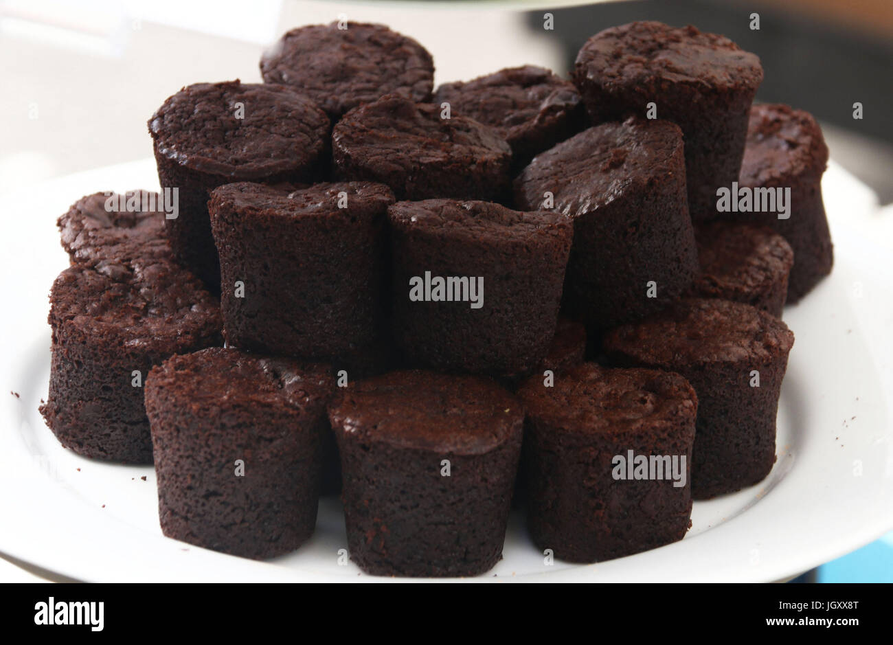 Gluten free brownies stacked on a white plate Stock Photo