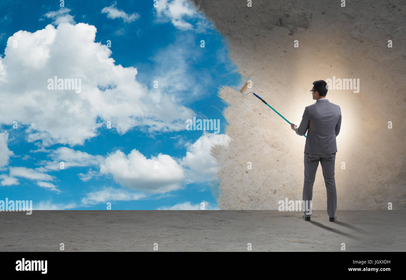 Businessman painting sky and clouds Stock Photo - Alamy