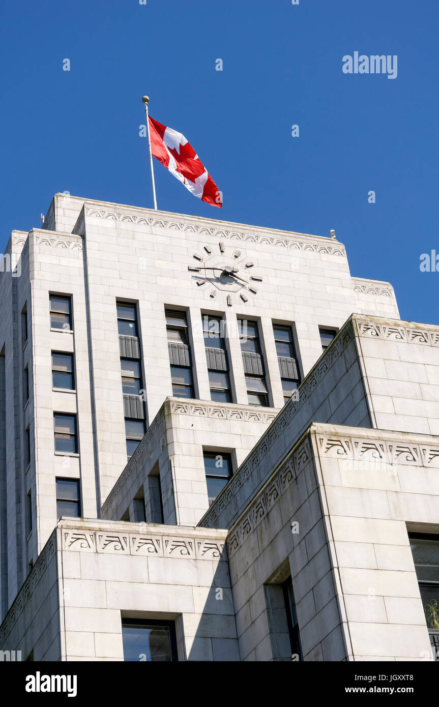 Canadian flag flying above the Art Deco style Vancouver City Hall building completed in 1936, Vancouver, British Columbia, Canada Stock Photo