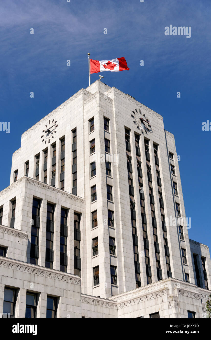 Canadian flag flying above the Art Deco style Vancouver City Hall building completed in 1936, Vancouver, British Columbia, Canada Stock Photo