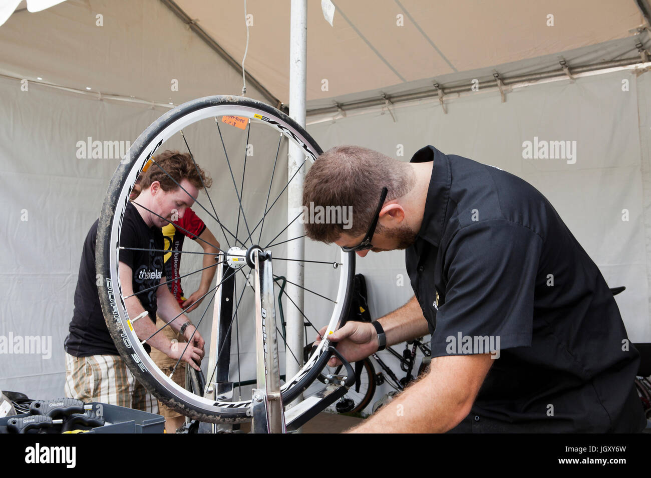 Bicycle mechanic truing a bike wheel - USA Stock Photo