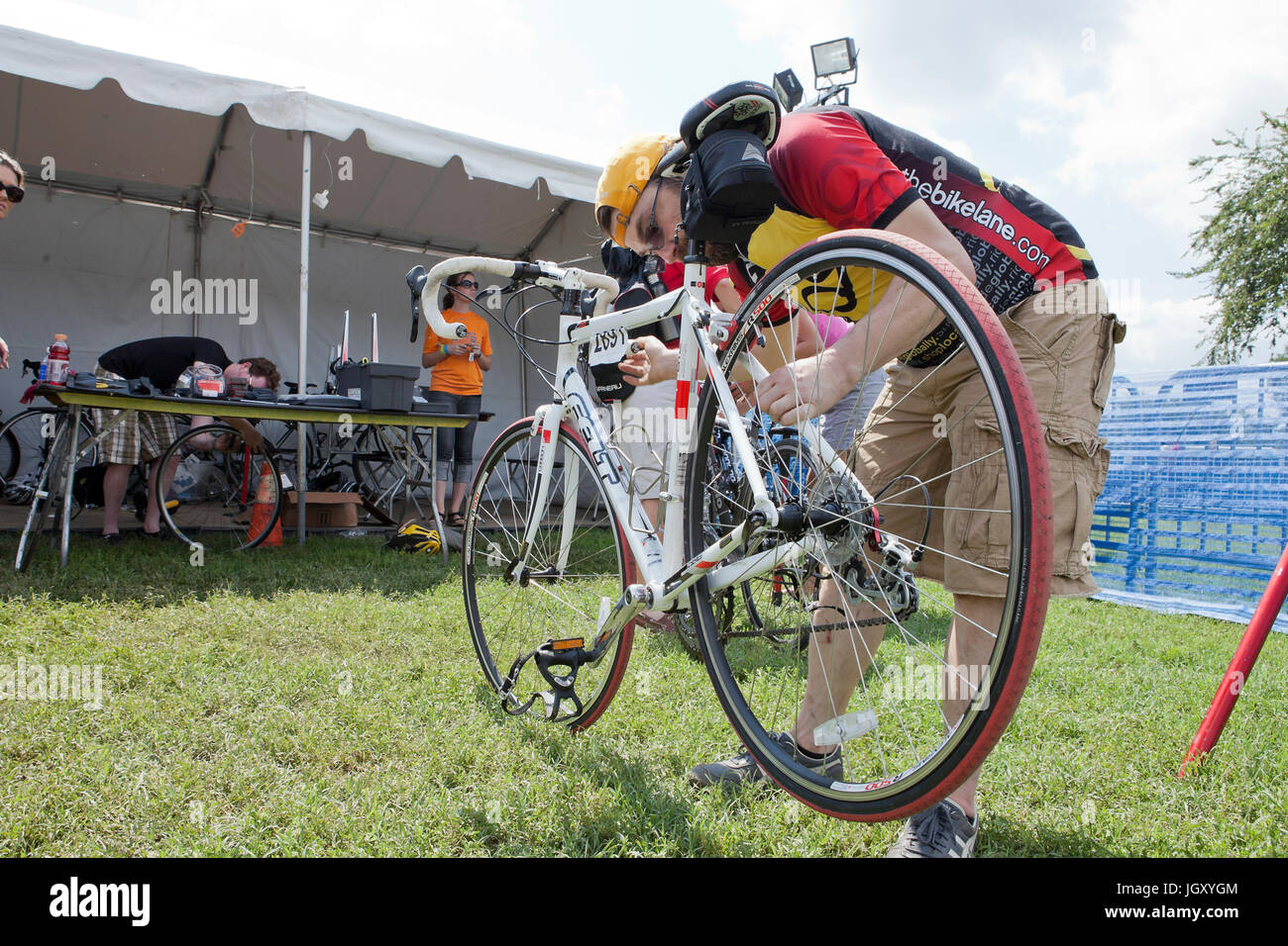 Bicycle mechanic fixing wheel - USA Stock Photo
