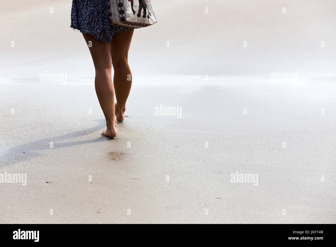 Woman walking barefoot on beach hi-res stock photography and images - Alamy