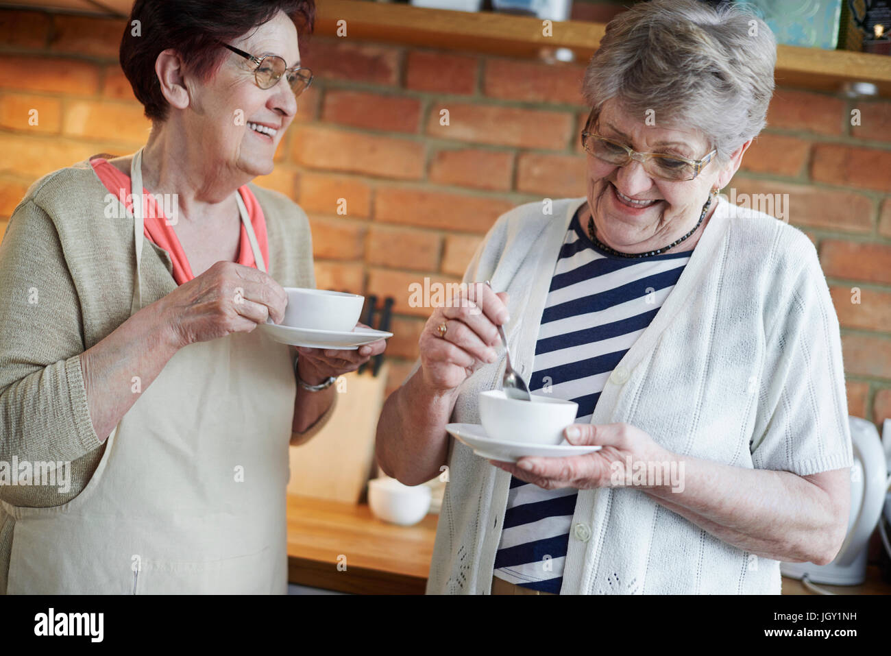 Senior adult women drinking coffee together Stock Photo