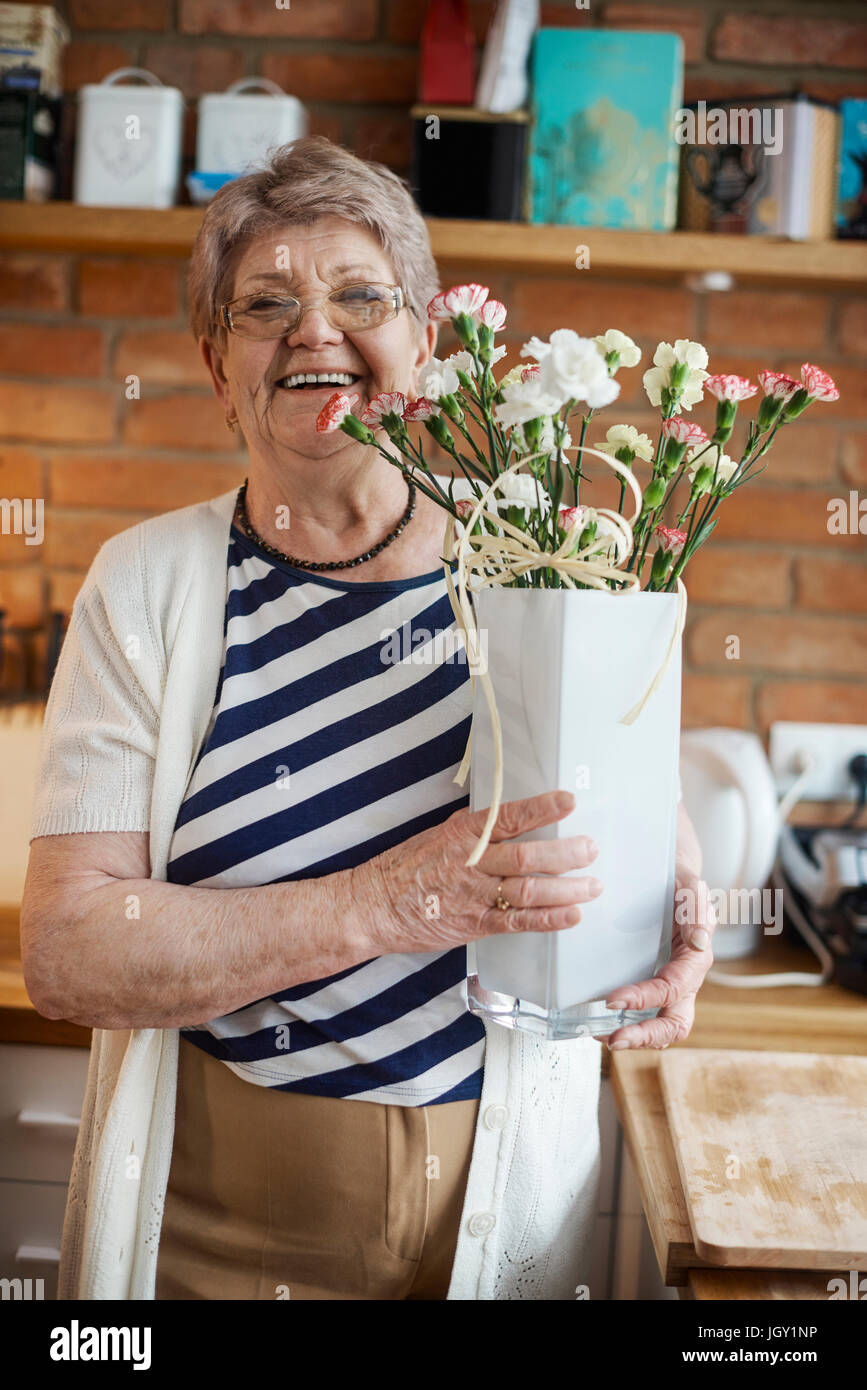 Senior adult woman with floral craftwork Stock Photo