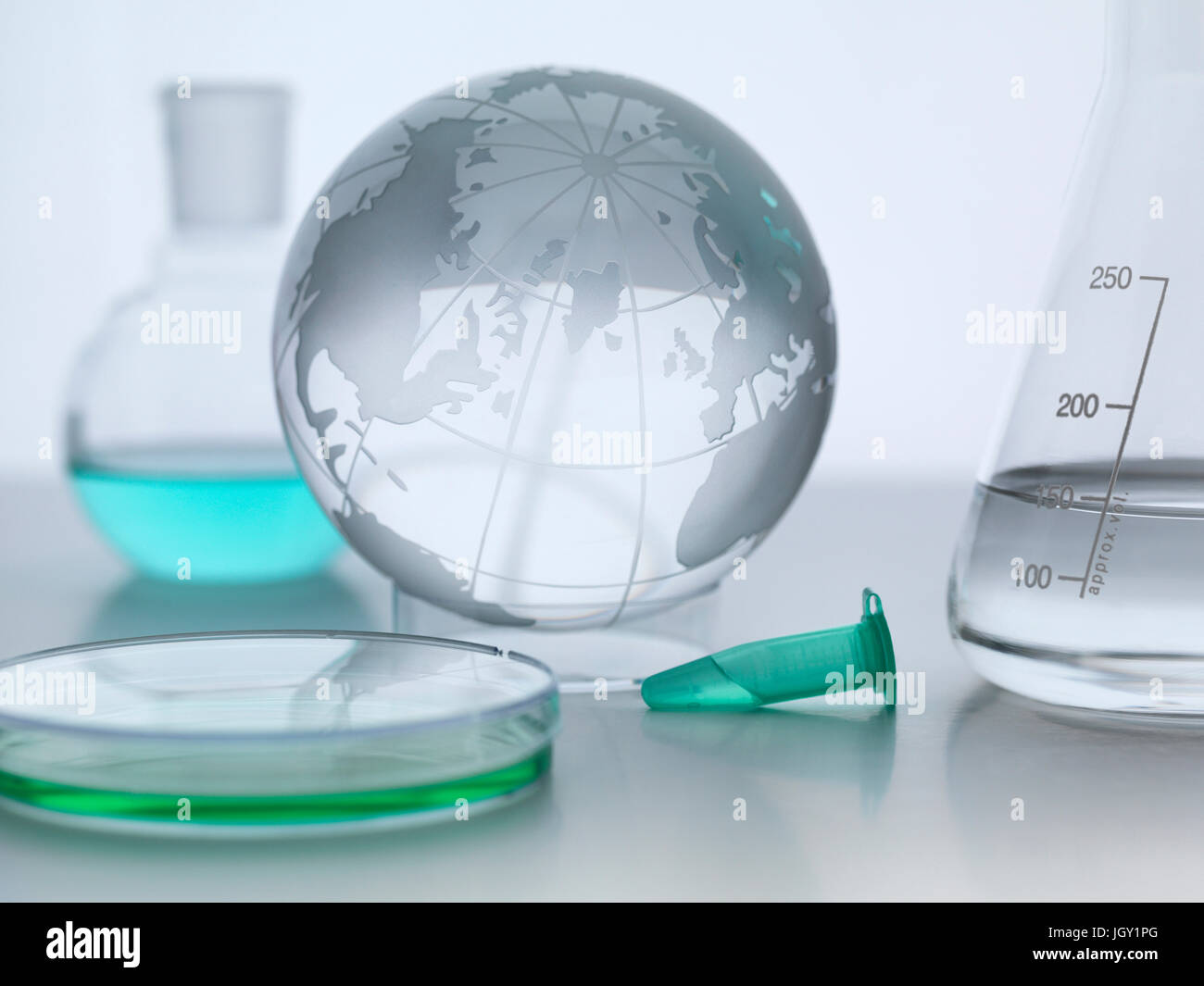 Globe with laboratory flasks and petri dish Stock Photo