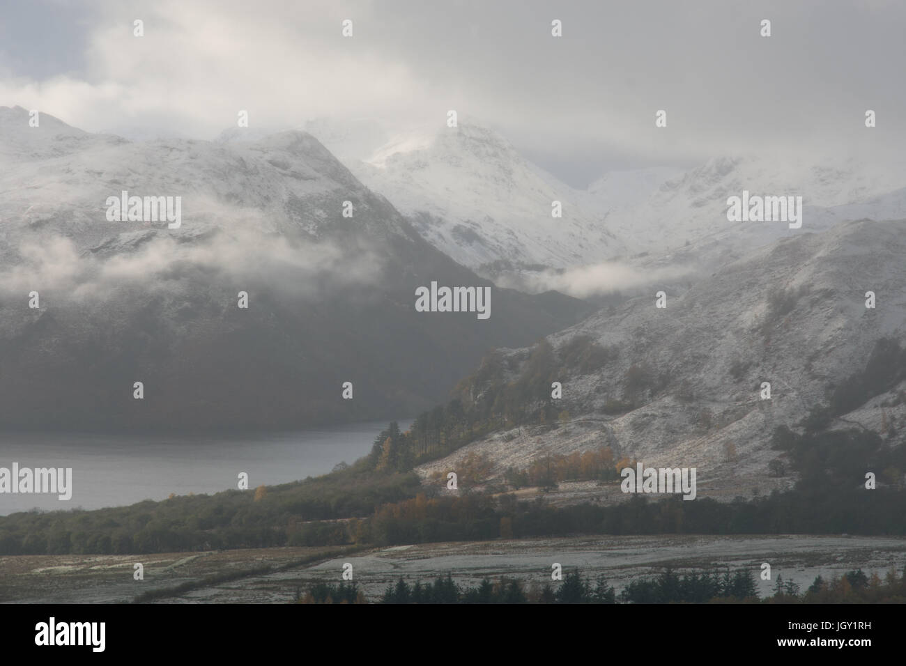 Low cloud and snow capped mountains at Ullswater, The Lake District, UK Stock Photo