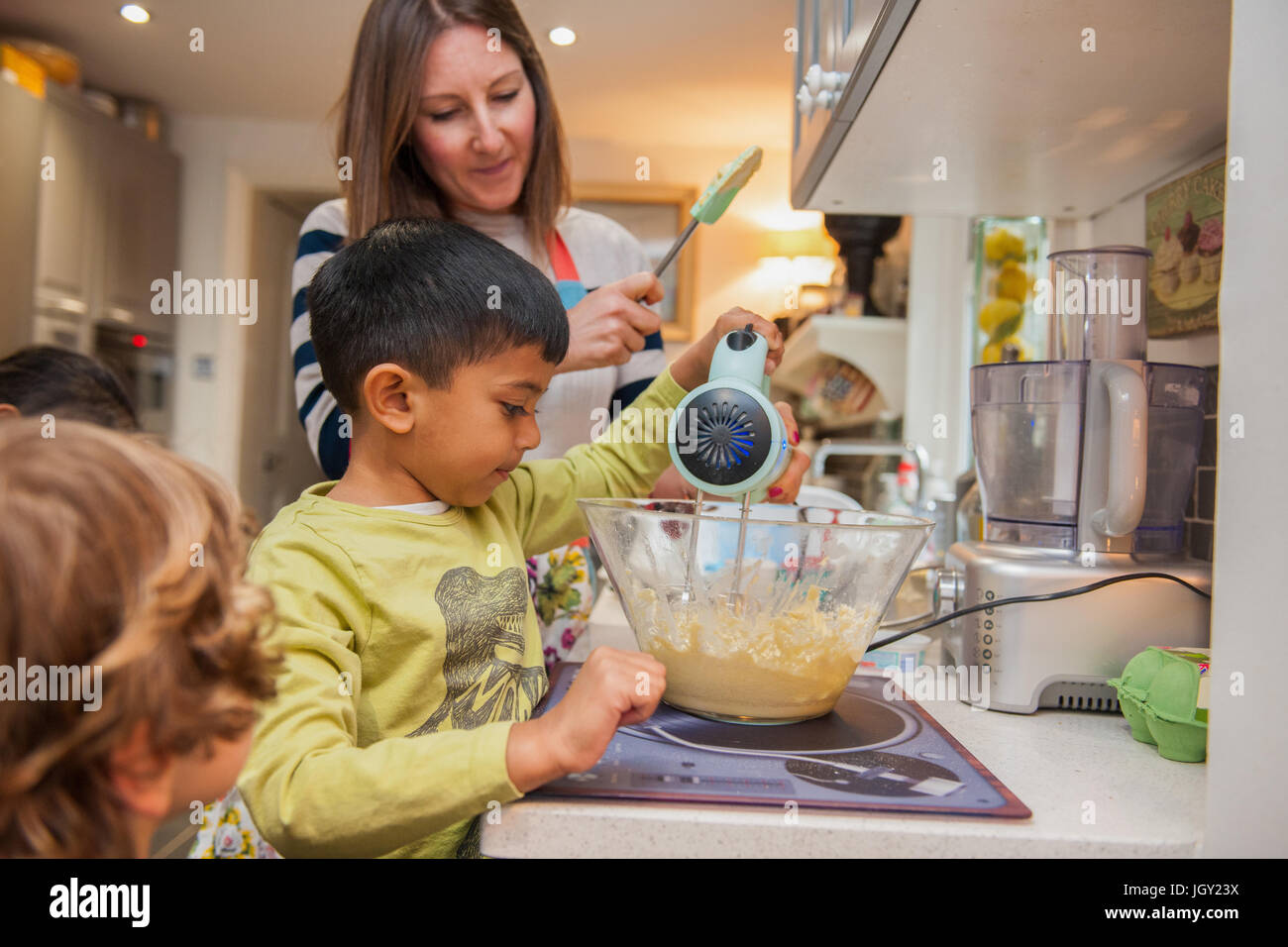 Childminder and children baking Stock Photo