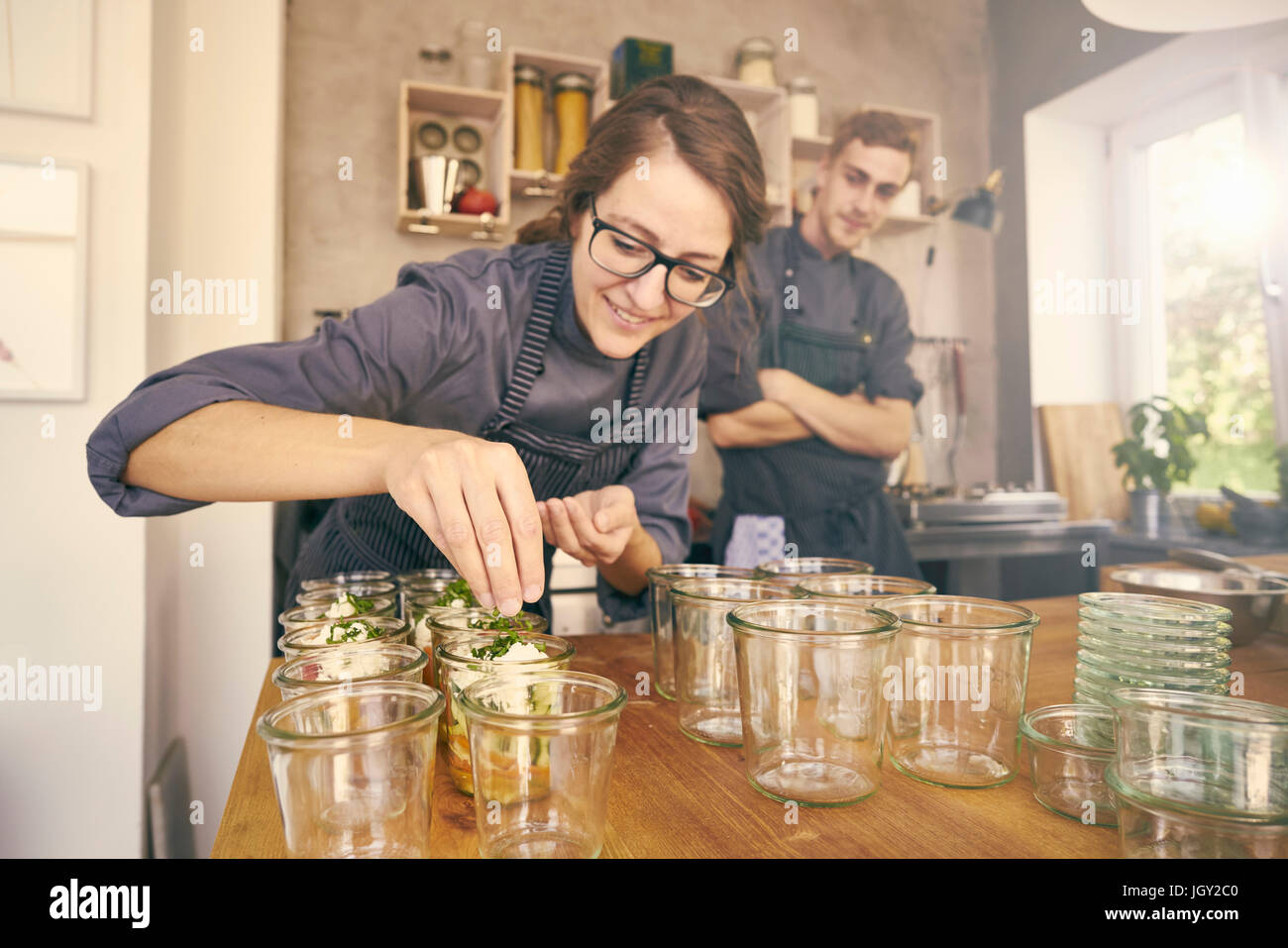 Chef filling plastic containers with portions of food Stock Photo Alamy