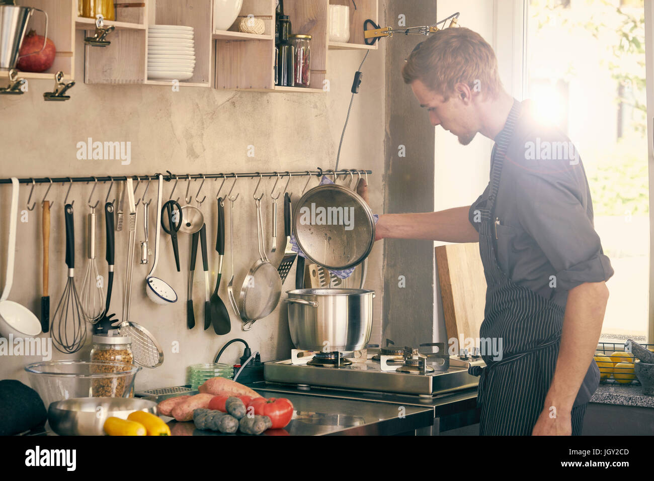 Chef cooking in commercial kitchen Stock Photo Alamy