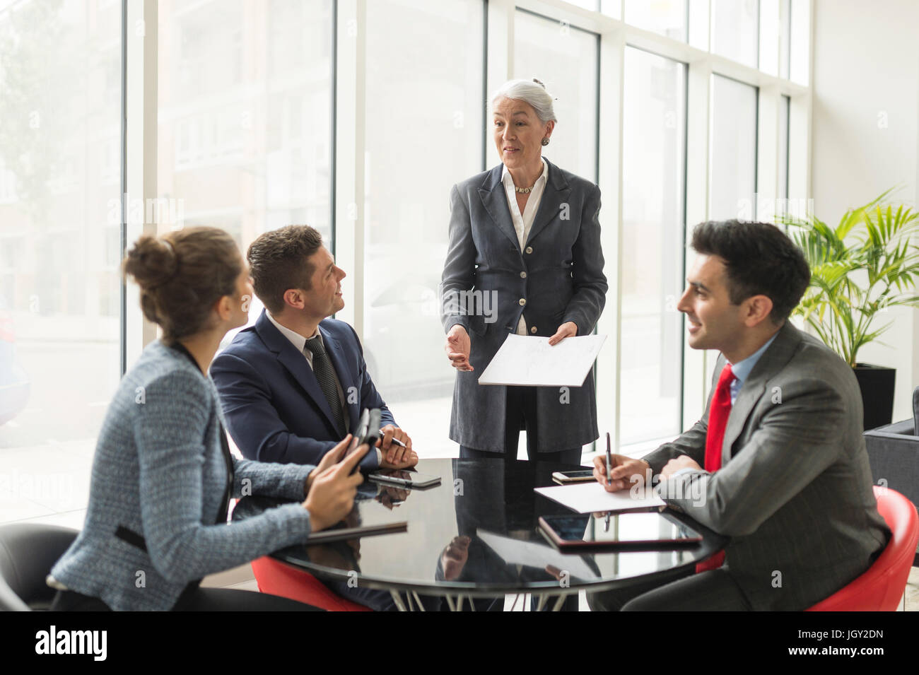 Businesswoman Explaining To Business Team In Boardroom