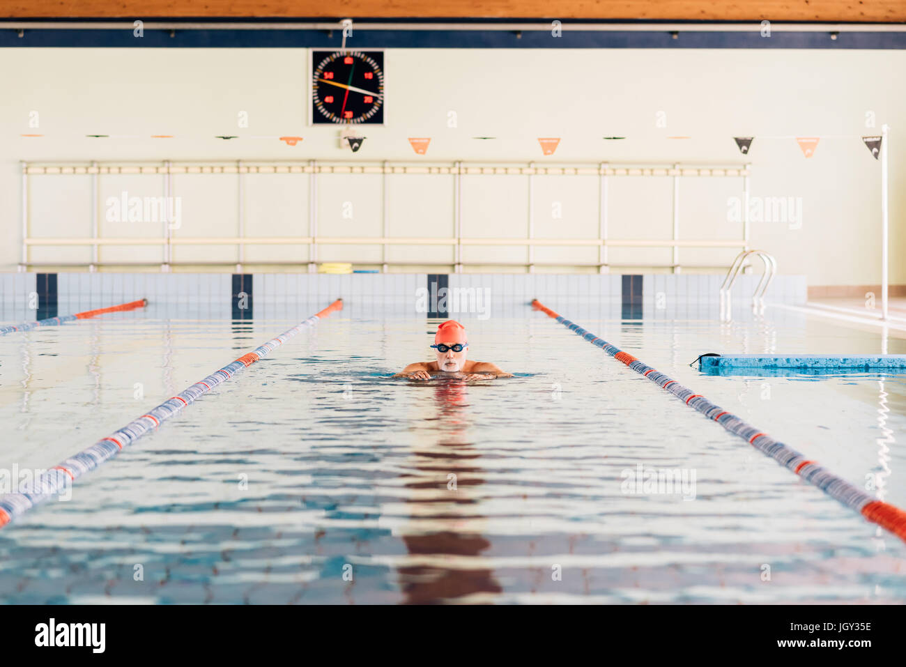 Senior man swimming in swimming pool Stock Photo