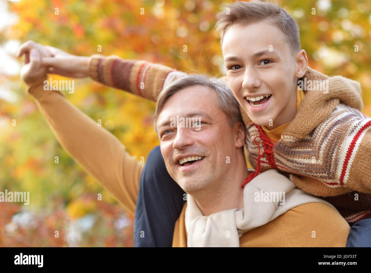 Father and son in autumn park Stock Photo - Alamy