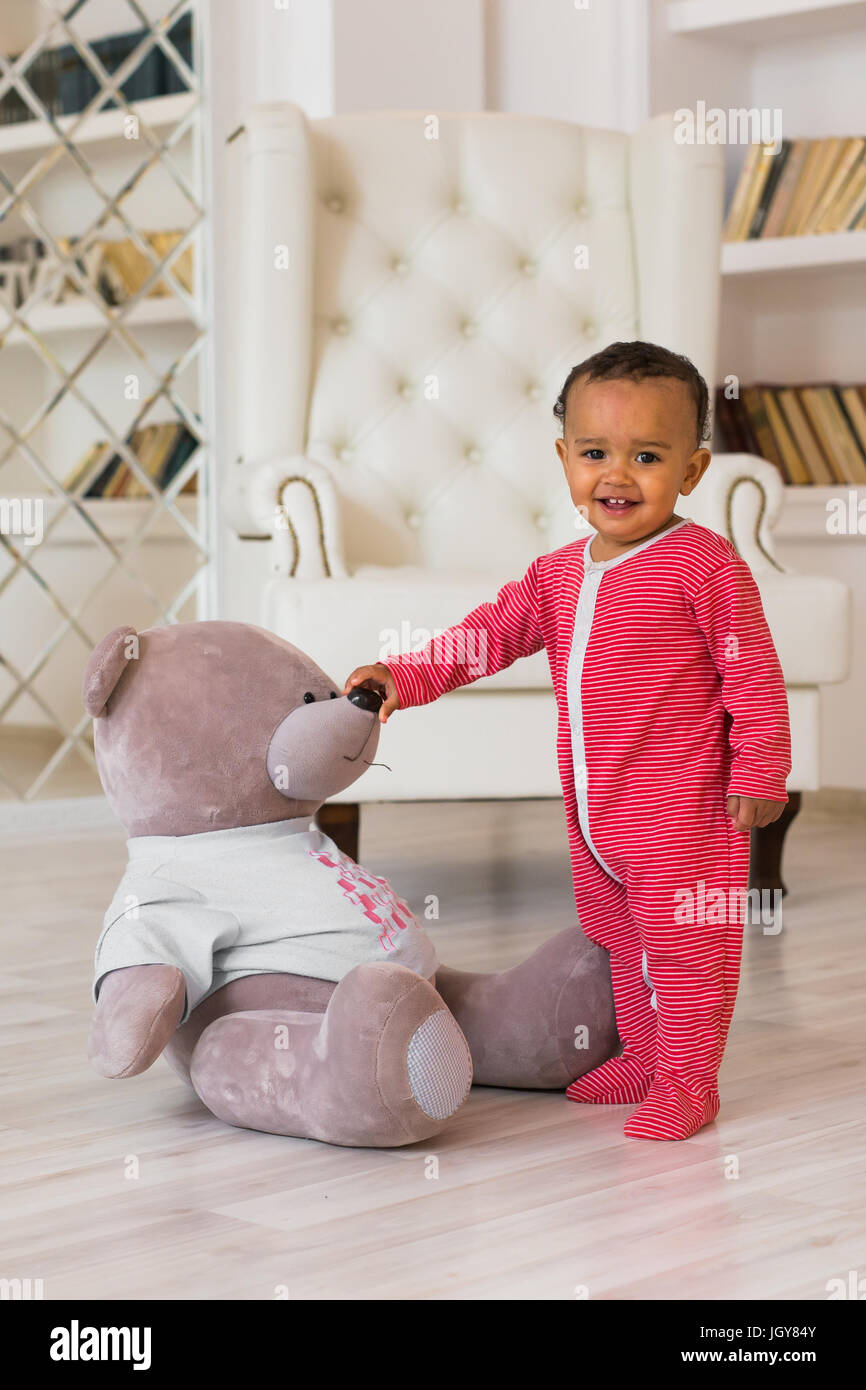 Happy baby boy playing with his teddy bear Stock Photo - Alamy
