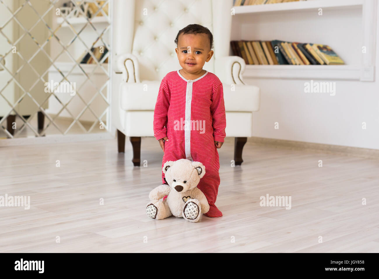 Happy baby boy playing with his teddy bear Stock Photo - Alamy