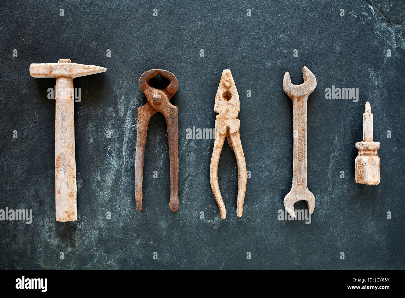 https://c8.alamy.com/comp/JGY85Y/rusty-like-tools-collection-made-of-chocolate-on-dark-slate-background-JGY85Y.jpg
