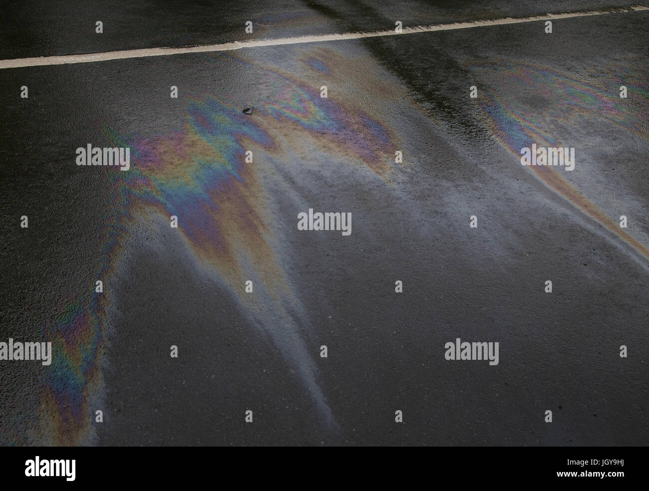 The coloured patterns produced by oil spillage on the road Stock Photo