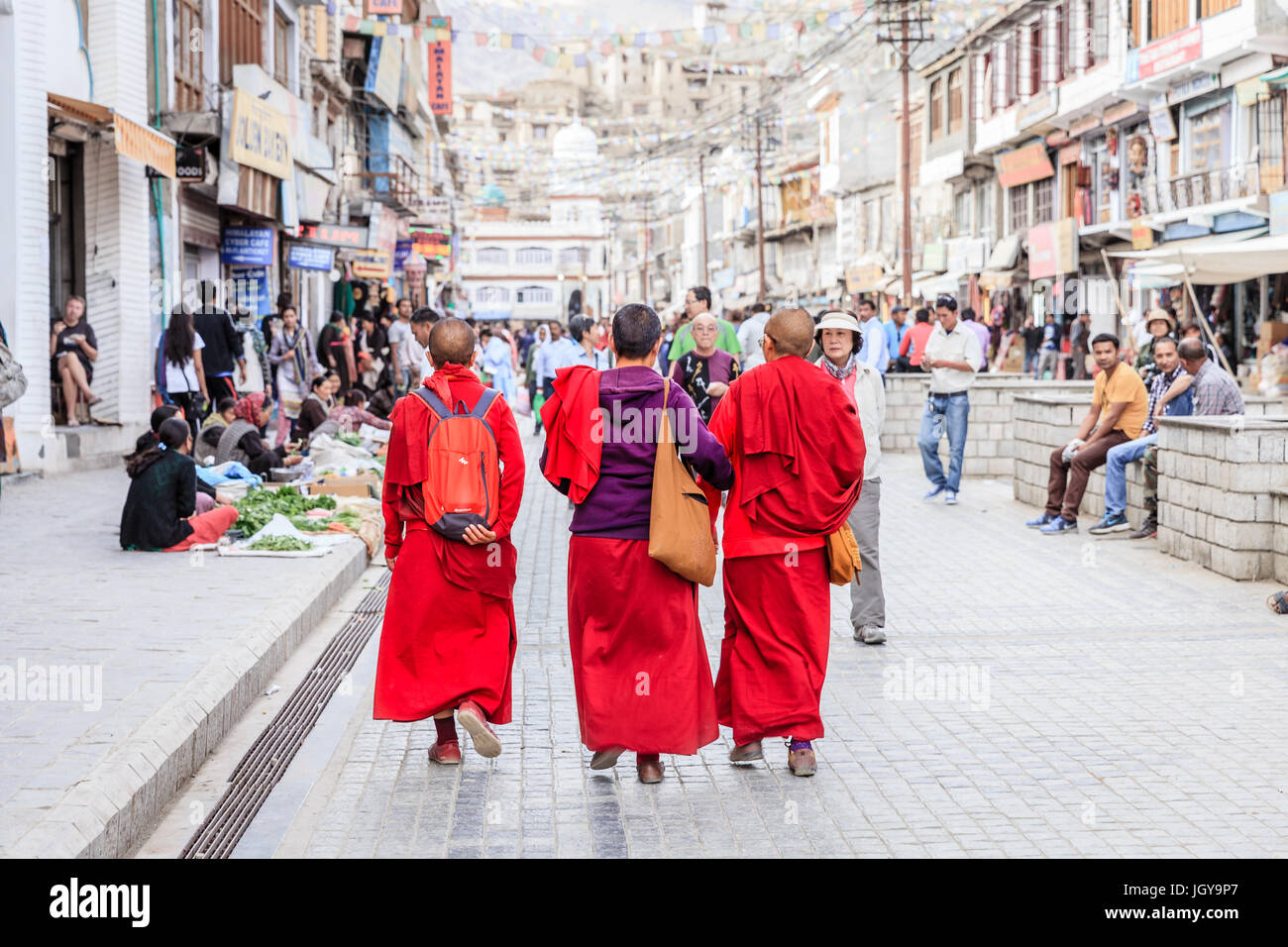 Leh, Ladakh, India, July 12, 2016: three Buddhist monks walking on the main shopping street in Leh, Ladakh district of Kashmir, India Stock Photo