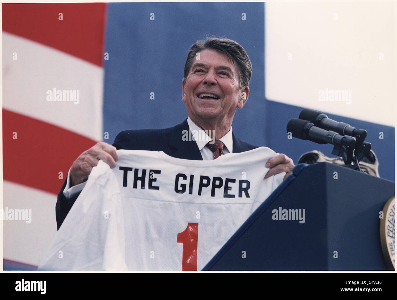 Ronald Reagan holds a football jersey emblazoned with The Gipper Stock Photo