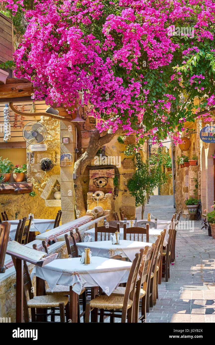Restaurant at Chania Old Town, blooming bougainvillea flowers, Crete Island, Greece Stock Photo