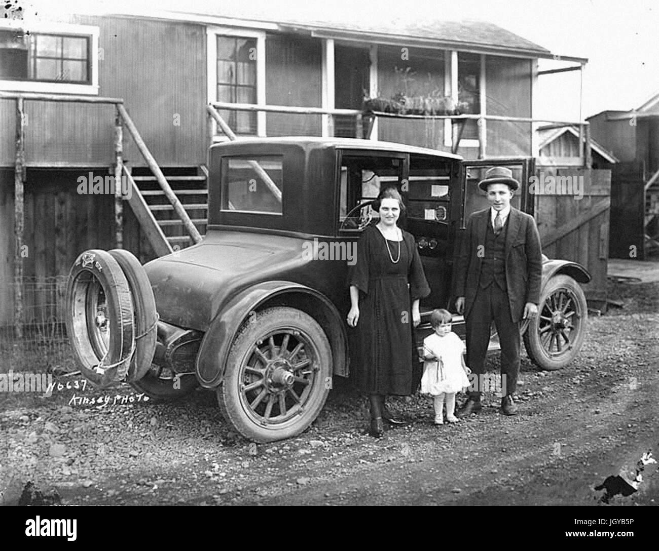 John Schafer with wife Neta Smith Schafer and daughter Bernice beside 1922 Buick Six automobile at railroad logging camp Stock Photo