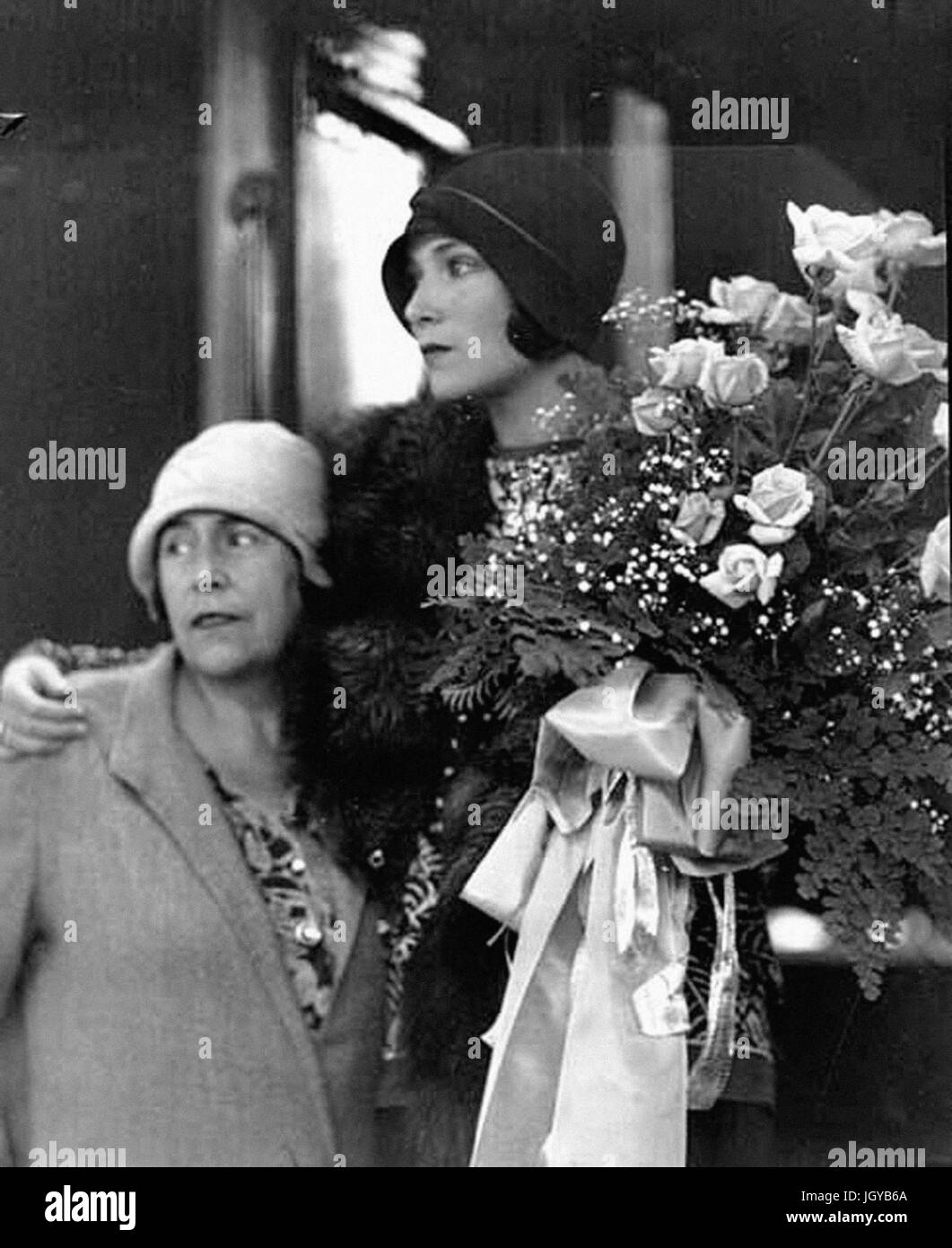 Dolores Del Rio with her mother on the steps of a train, holding a ...