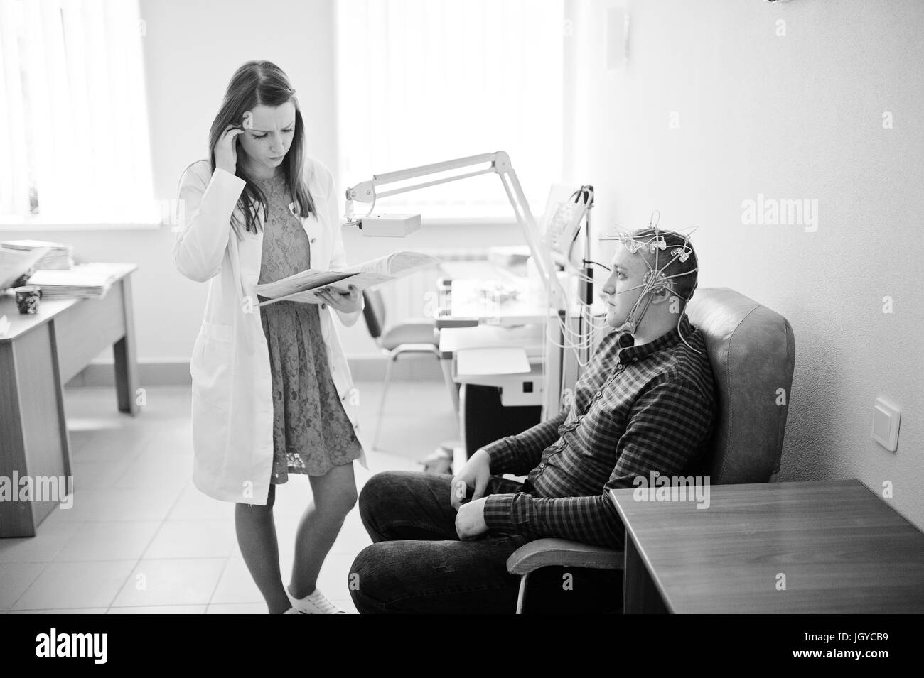 Attractive female doctor examining patient Black and White Stock Photos ...