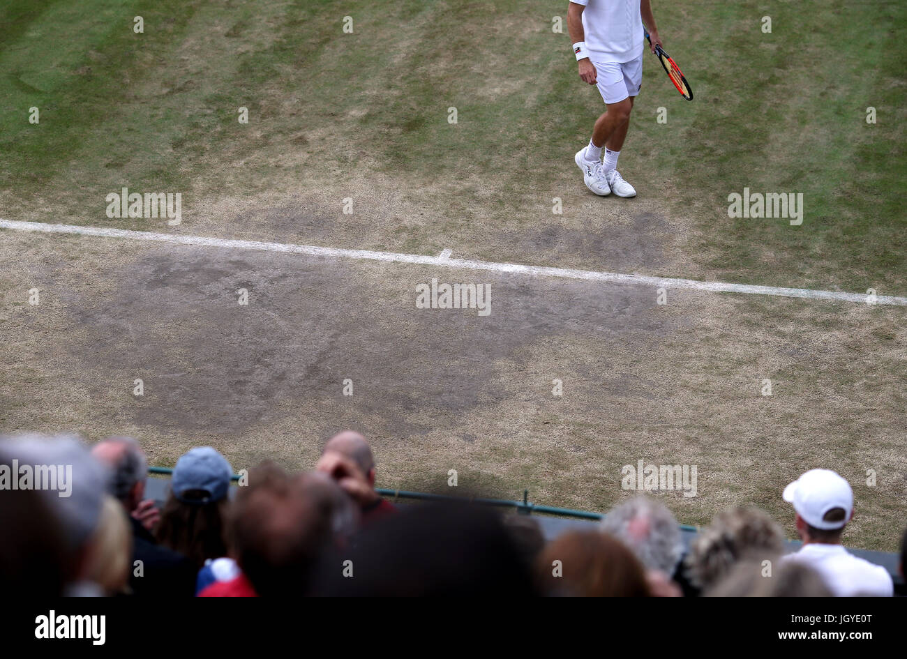General view of the wear and tear to the grass on the baseline of court two on day eight of the Wimbledon Championships at The All England Lawn Tennis and Croquet Club, Wimbledon. Stock Photo