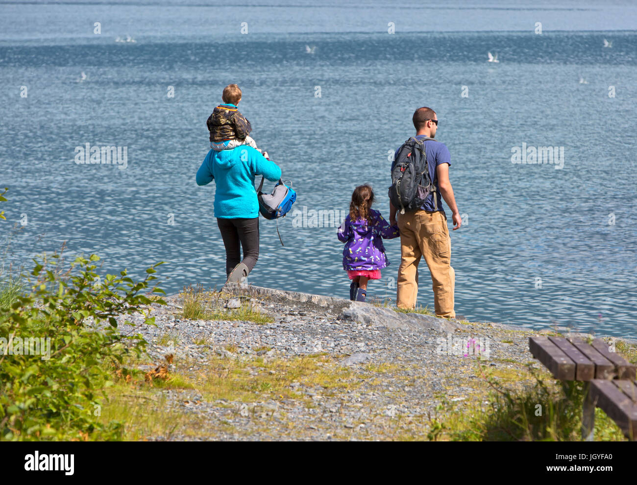 Family walking by Solomon Gulch Fish Hatchery, Bay Of Valdez. Stock Photo