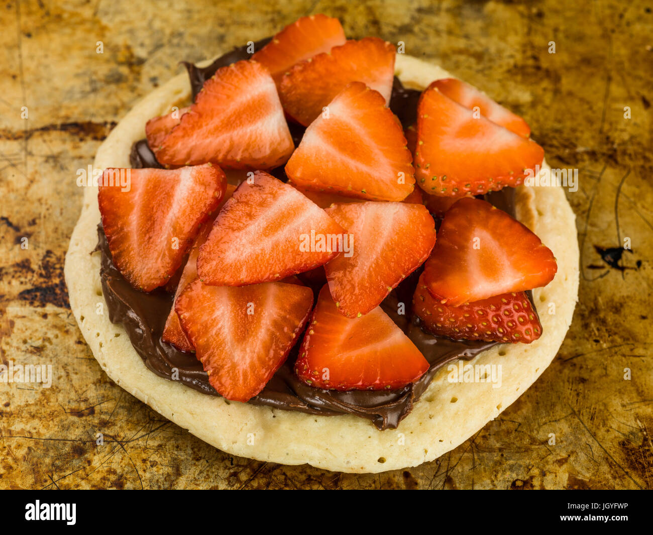 Pancake With Strawberries and Chocolate Spread Sitting on an Over Tray Stock Photo