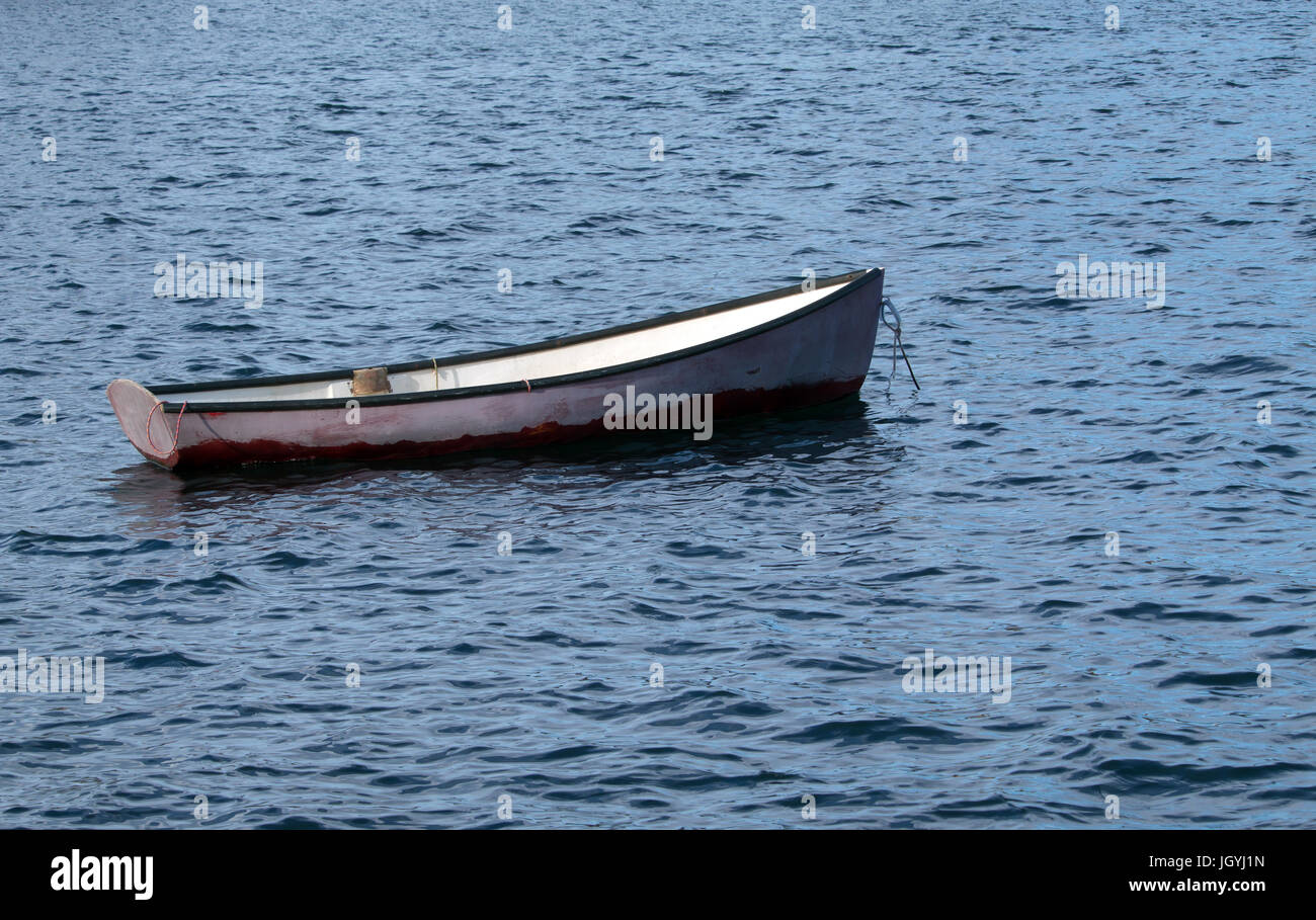 One empty rowboat at anchor Stock Photo - Alamy