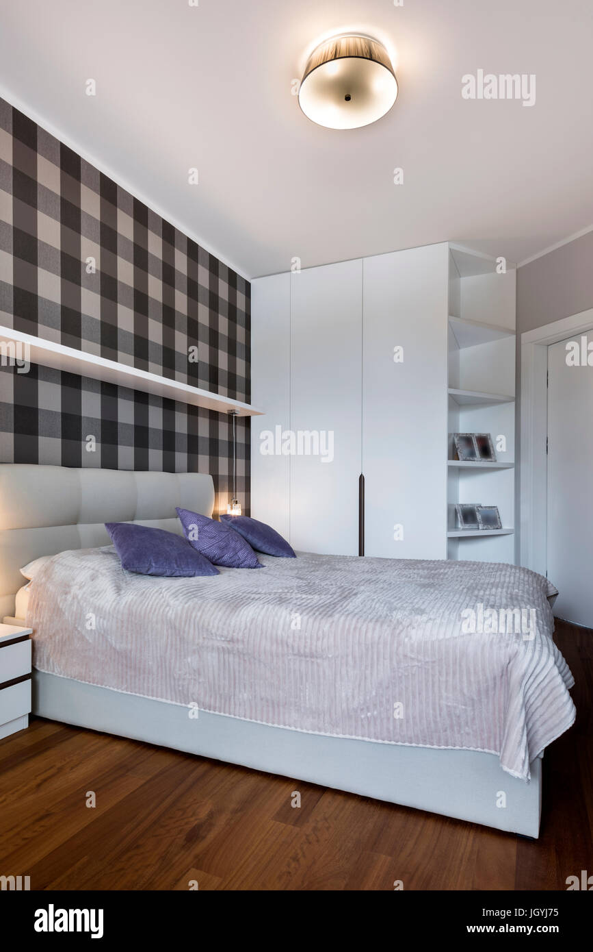 Modern Bedroom With Checker Pattern On The Wall And Wardrobe