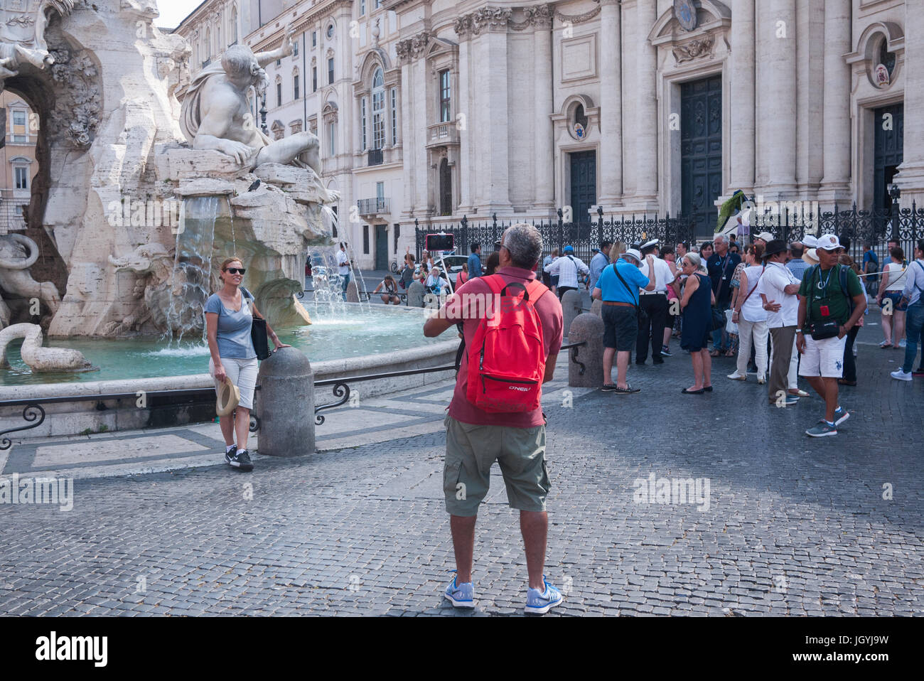 Rome, Italy 2017 - A man takes a photo of a woman in Piazza Navona Stock Photo