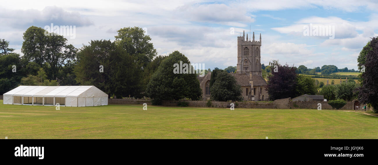 Newton St. Philip church and village green. Idyllic English village with ancient church of St. Philip and St. James and cricket pitch, Somerset, UK Stock Photo