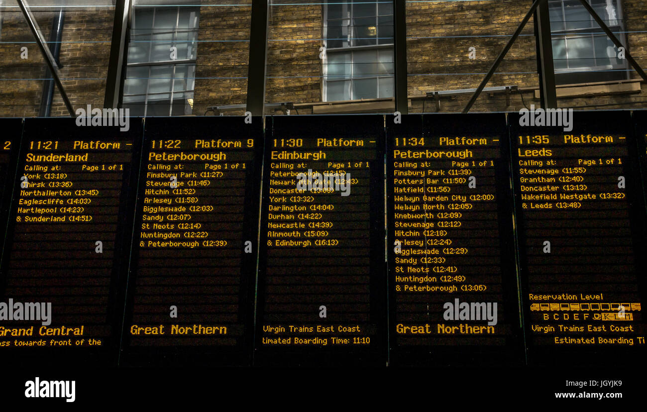 Destinations board with departure information for travel on main concourse at King's Cross Station, London, England, UK Stock Photo