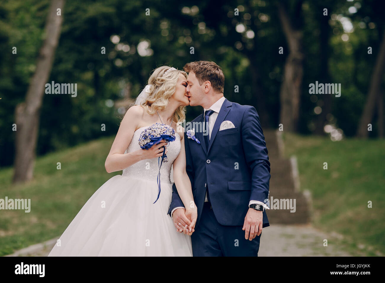 wedding couple Park walk suit Sunny outdoors Stock Photo - Alamy