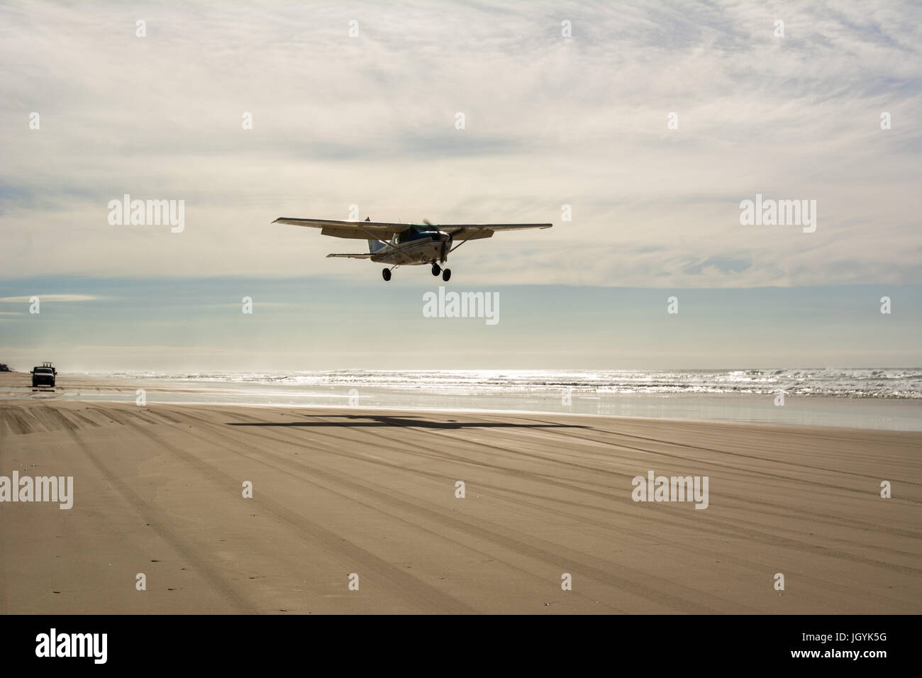 Small airplane coming in to land on the beach runway on Fraser Island, Queensland, Australia. Stock Photo