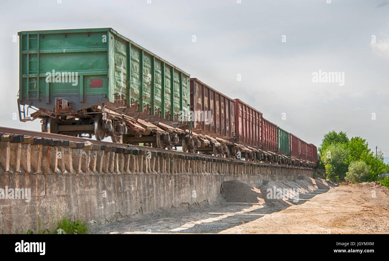 Railway truck parked at the station waiting for unloading Stock Photo