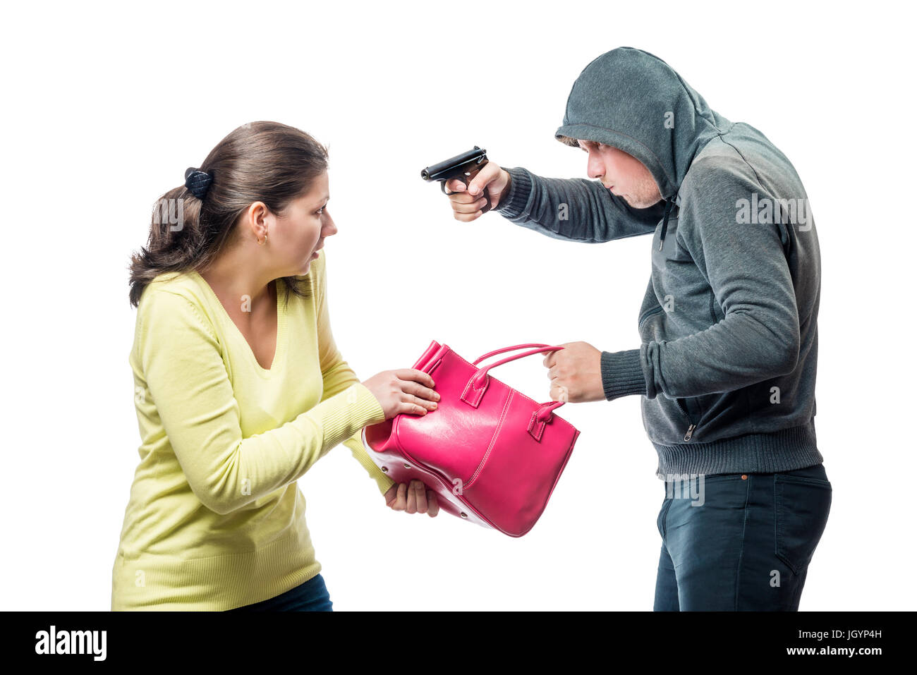 Thief threatens a victim with a gun, steals a bag Stock Photo